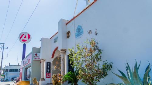 a building on a street with a no parking sign at Hotel María Bonita by Chavira in Nuevo Laredo