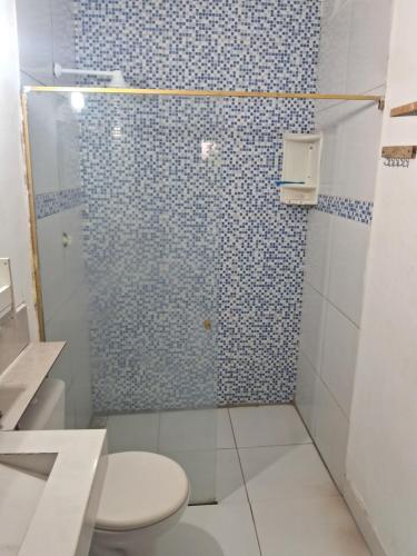 a bathroom with a glass shower with a toilet at Casa blue in Aracati