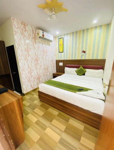 a bedroom with a large bed in a room at Airport Inn Residency Mumbai in Mumbai