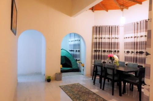 a dining room with a table and a tent at Village Breeze Villa in Haputale