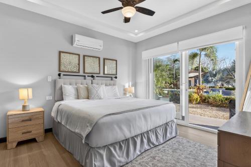 a bedroom with a bed and a large window at The Point 23 At Playa Avellanas in Playa Avellana