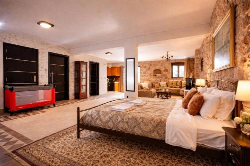 a bedroom with a bed and a living room at Villa Anemos in Nafplio