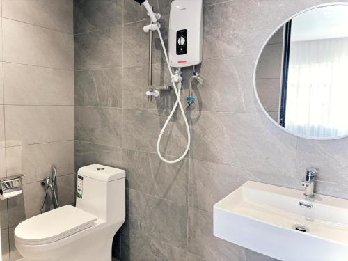 a bathroom with a shower and a toilet and a sink at Muari Boutique Hotel in Muar