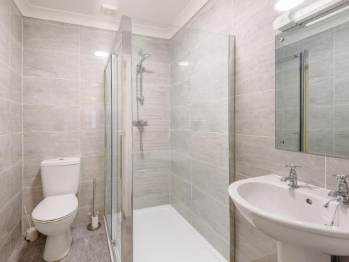 a bathroom with a toilet and a sink and a shower at Dawson Park 6 - Uk12665 in Mablethorpe