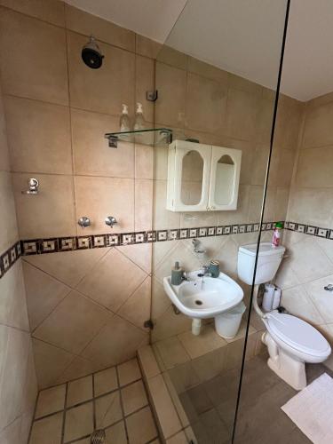 a bathroom with a toilet and a sink at Sea Spray B103 in Cape Town