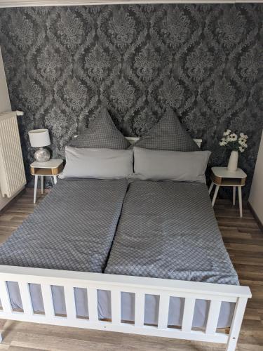 a bed in a bedroom with a wall at Eva's Home in Müllenbach