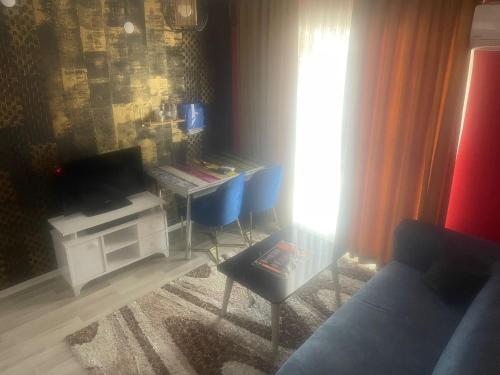 a living room with a couch and a table and a desk at Royal Palace Boutique Otel Boudja in Buca