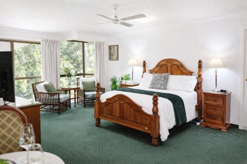a bedroom with a bed and a table and chairs at Mountain Sanctuary Retreat in Mount Tamborine