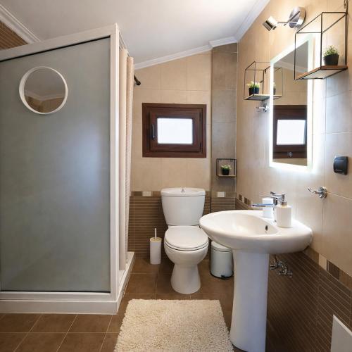 a bathroom with a toilet and a sink at Teo`s Seaview Specious Apartment, Nikiti near Harbor in Nikiti