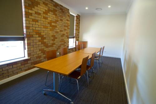 a conference room with a wooden table and chairs at Scone Motor Inn & Apartments in Scone
