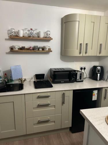a kitchen with a sink and a microwave at Swansea Waterfront in Swansea