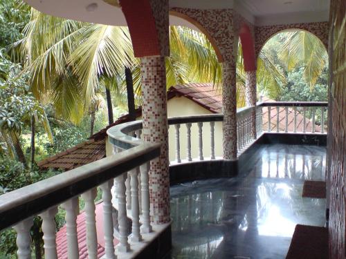 a house with a swimming pool on a balcony at Mama Mids Home in Morjim