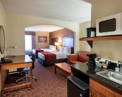 a hotel room with a bed and a bathroom at Comfort Suites Dulles Airport in Chantilly