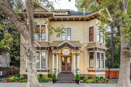 a yellow house with a clock on it at Hotel Napa Valley, an Ascend Collection Hotel in Napa