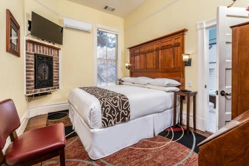 a bedroom with a bed and a fireplace at Hotel Napa Valley, an Ascend Collection Hotel in Napa