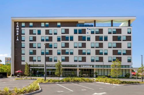 an office building with a parking lot in front of it at Cambria Hotel Orlando near Universal Theme Parks in Orlando
