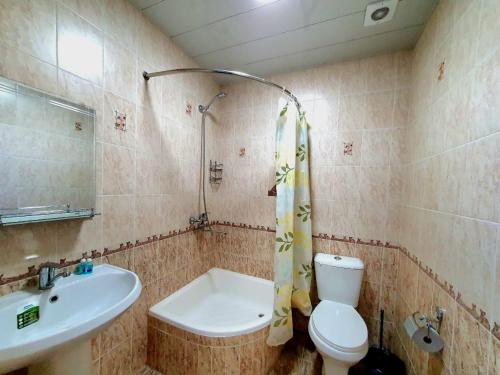 a bathroom with a sink and a toilet and a shower at DREAM PLAZA HOTEL for your convenience in Bukhara