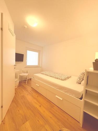 a small bedroom with a bed and a television at Guesthouse Fuschlsee in Hof bei Salzburg