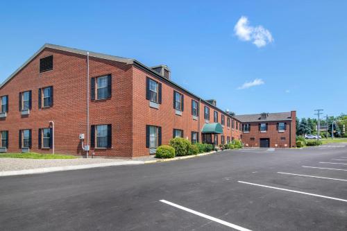 an empty parking lot in front of a brick building at Quality Inn at Bangor Mall in Bangor