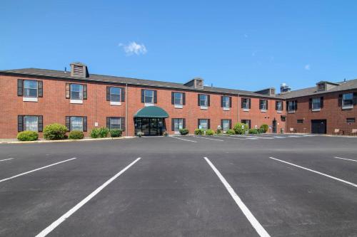 an empty parking lot in front of a large brick building at Quality Inn at Bangor Mall in Bangor