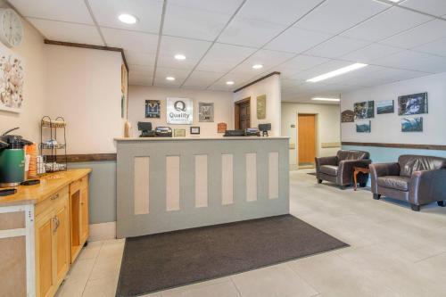 a waiting area in a clinic with chairs and a counter at Quality Inn at Bangor Mall in Bangor