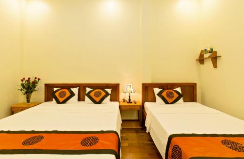 Postel nebo postele na pokoji v ubytování Qua Cam Tim Homestay