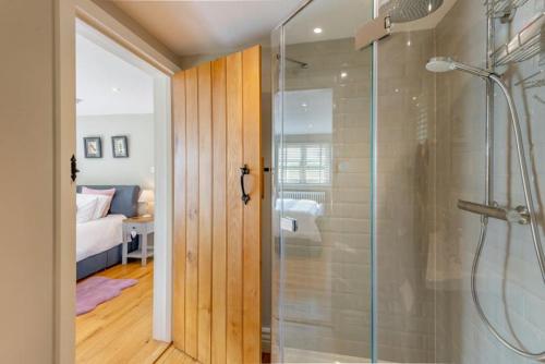 a bathroom with a shower with a glass shower backdoor at The Gate Lodge - Pet Free - Near Finchingfield & Saffron Walden in Great Sampford
