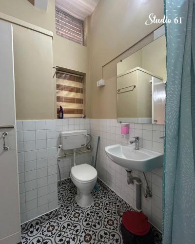 a bathroom with a toilet and a sink at Studio 61 Saltlake Sector 1 Kolkata in kolkata