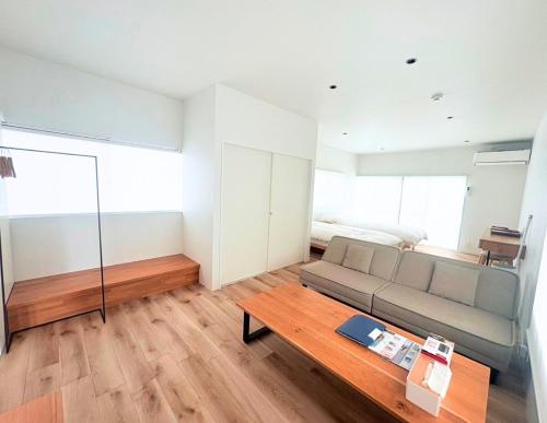 a living room with a couch and a table at 果実の見える宿 in Koshu