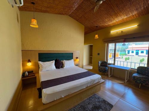 a bedroom with a large bed and a large window at Eeja Resto and Cafe in Garappu