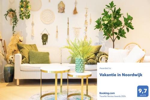 a living room with a couch and two tables at Vakantie in Noordwijk in Noordwijk