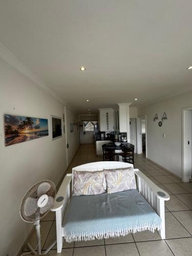 a living room with a couch and a table at Mangrove Beach Estate Boboyi in Port Shepstone