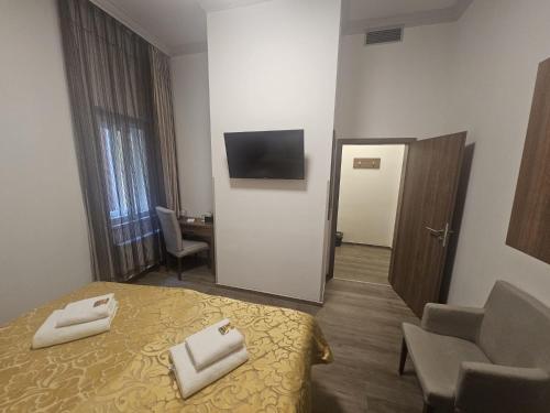 a hotel room with a bed and a television at Hotel Prague Star in Prague