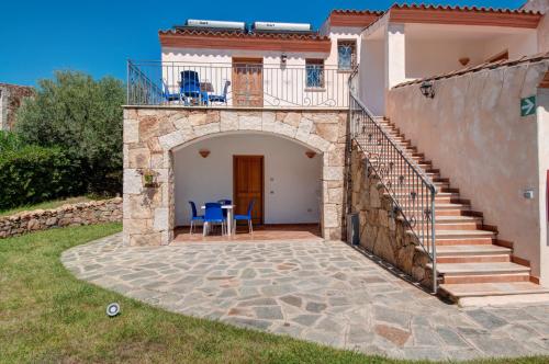 an external view of a house with a patio and stairs at Residence Bouganvillage in Budoni