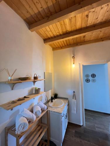 a bathroom with a sink and a counter with towels at Casa do Mestre in Amieira