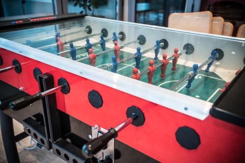 a red table with toy men playing a game of bowling at Almaas Hotell Stord AS in Stord