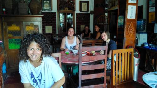 a group of women sitting at a table in a restaurant at Mini Tiga Homestay in Pangandaran