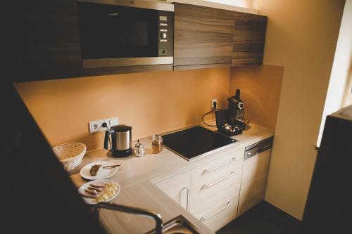 a small kitchen with a sink and a microwave at Arabella Retreat & Spa in Nauders