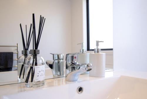 a bathroom sink with a faucet and a mirror at Hāwea Home Haven in Lake Hāwea
