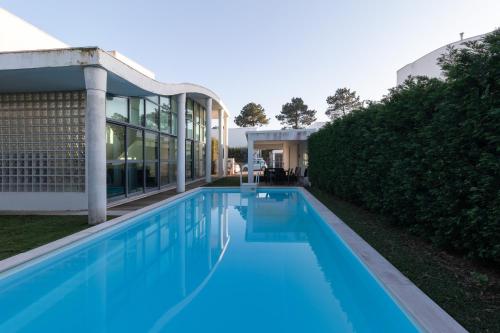 a swimming pool in front of a house at Villa 4 Rooms, Swiming Pool Pink in Palmela