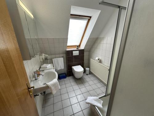 a bathroom with a sink and a toilet at Fehmarn 17-1 in Fehmarn