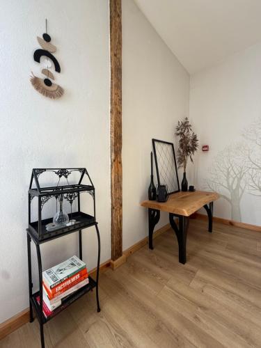 a room with a table and a bench and a fan at visitDINAMO in Kandava