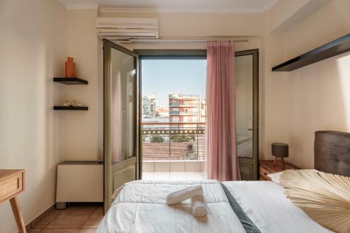 a bedroom with a bed and a large window at 3BD Apartment in the Center - Self check in in Patra
