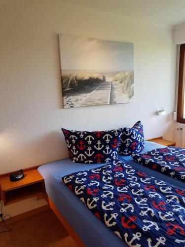 a bedroom with a bed and a picture of a beach at Feriengarten Dahme W 13 in Dahme