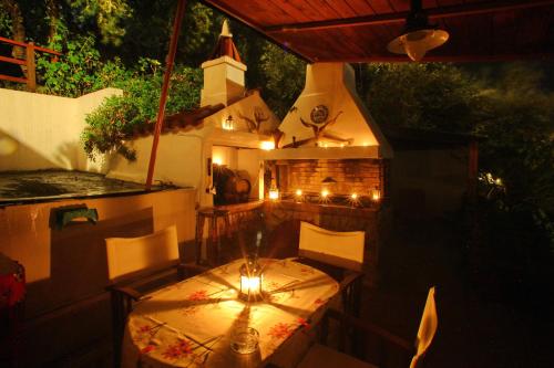 a table and chairs on a patio at night at Irene' s Paradise in Skopelos Town
