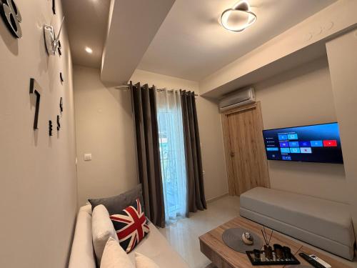 a living room with a couch and a tv at Aggelos Room 1 in Volos