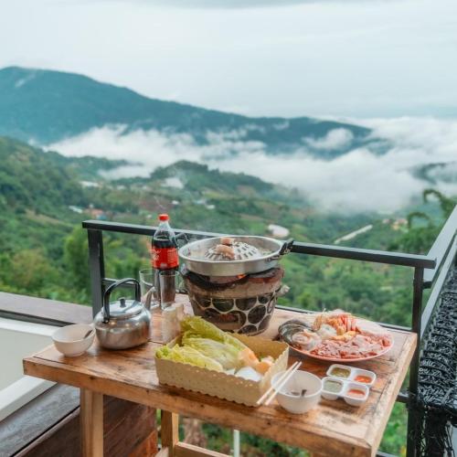 a table with food on top of a balcony at ม่อนสาเคียงดาว in Ban Thung Phan Ha