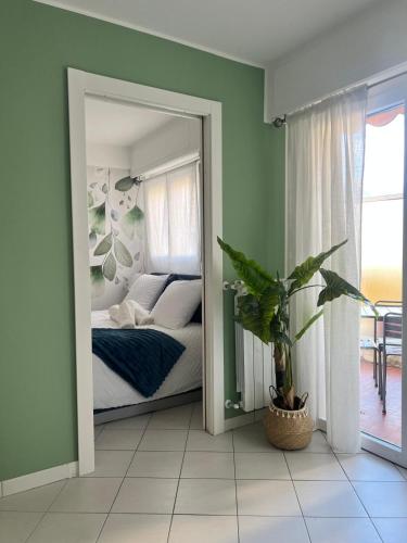 a mirror in a bedroom with a bed and a plant at Gamiga in Menton