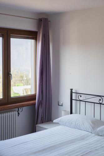 a bedroom with a bed and a window at Appartamenti Ceccherini Debora Alice in Malcesine