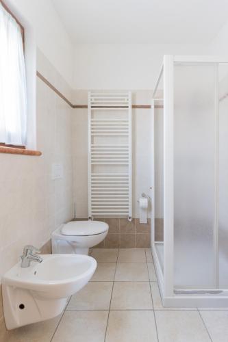 a bathroom with a toilet and a sink and a shower at Appartamenti Ceccherini Debora Alice in Malcesine